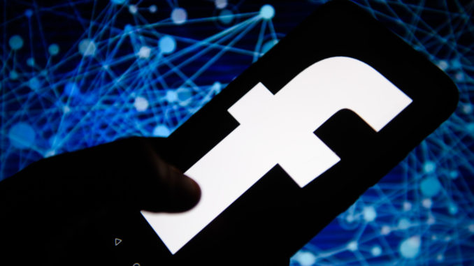 Black facebook logo is seen on an android mobile phone