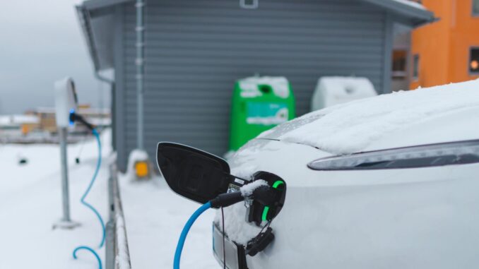 Electric car charging outdoors in the winter.